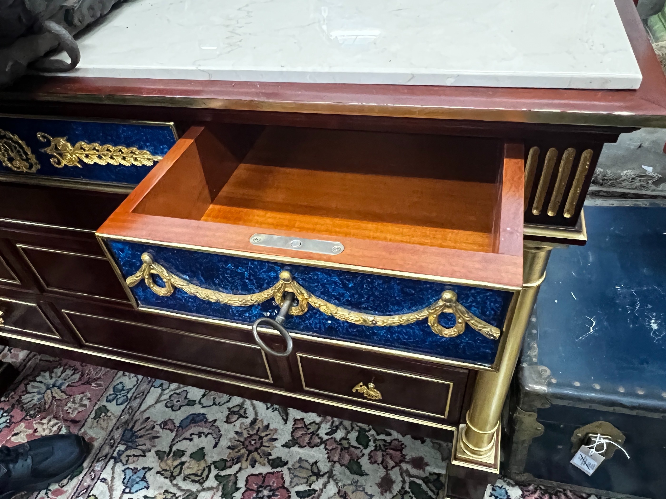 An Empire style faux malachite parcelgilt mahogany marble top commode, width 130cm, depth 50cm, height 85cm